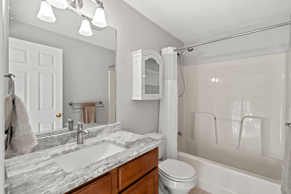 23 Morrison Lane Westford, MA 01886 - Photo 31 of 37 a bathroom with a granite countertop sink toilet a mirror and shower