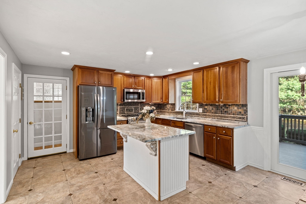23 Morrison Lane Westford, MA 01886 - Photo 6 of 37 a kitchen with stainless steel appliances granite countertop a stove a refrigerator a sink dishwasher and a open refrigerator