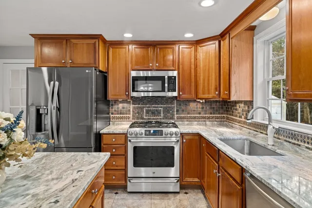 a kitchen with a stove a sink and a refrigerator