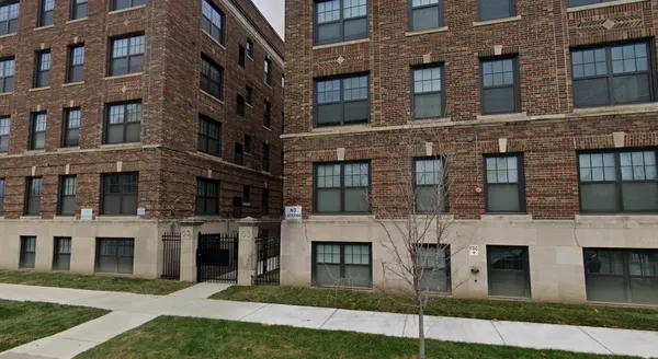a view of a brick building with many windows