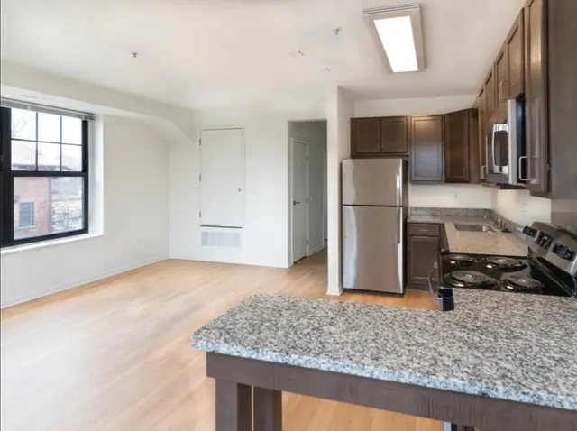 a kitchen with a refrigerator sink and stove