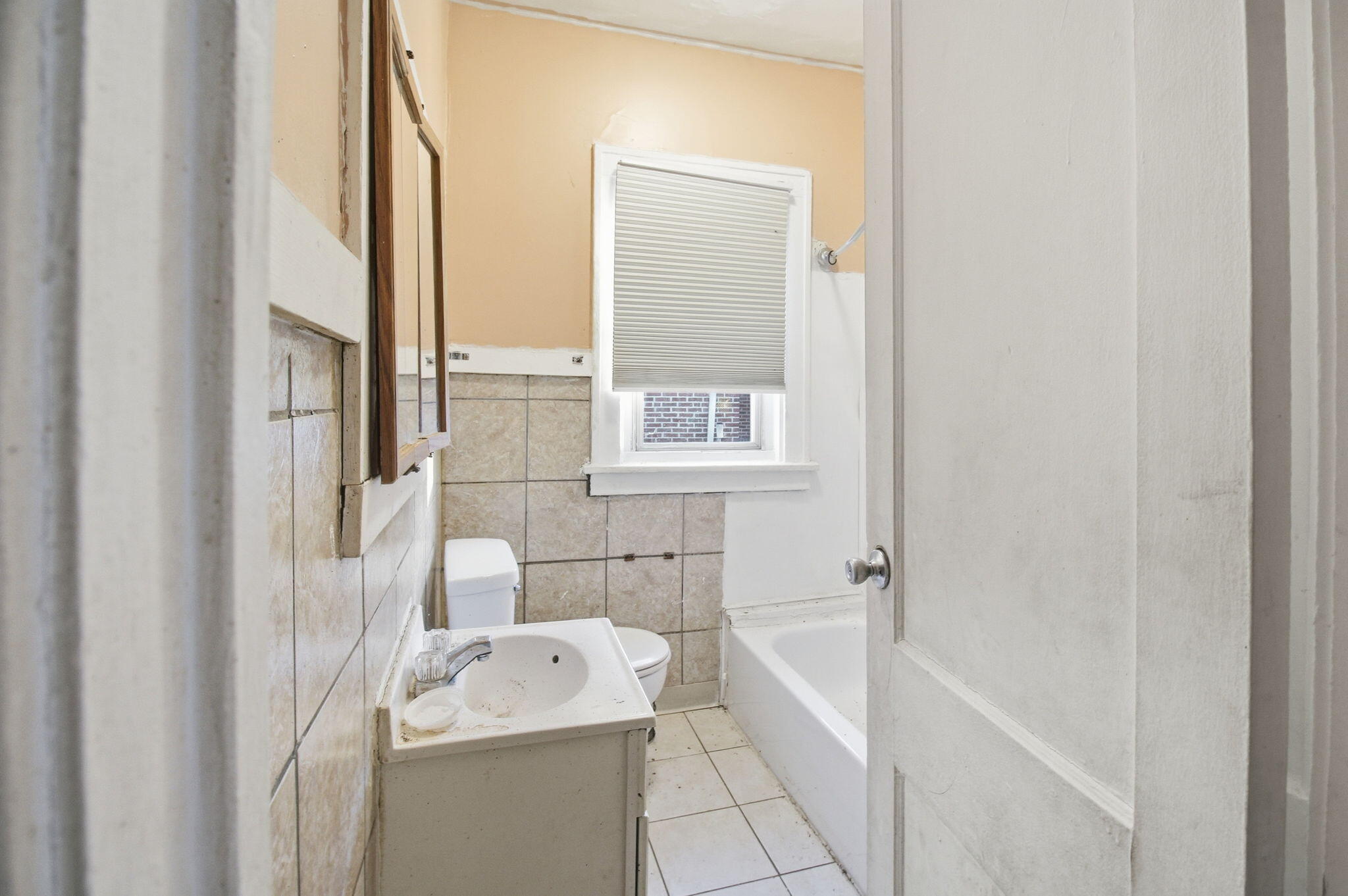4427 Washington Street Gary, IN 46408 - Photo 7 of 9 a bathroom with a sink a toilet and a bathtub