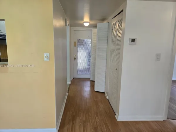 a view of a hallway with wooden floor