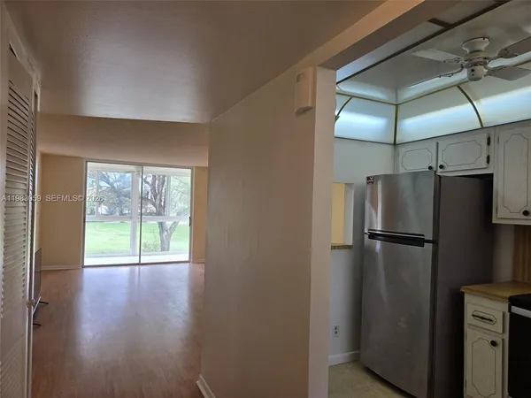 a kitchen with a refrigerator a table and chairs