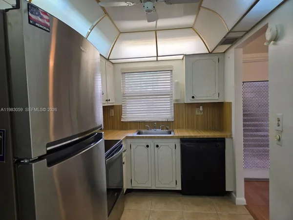 a kitchen with a sink and a refrigerator