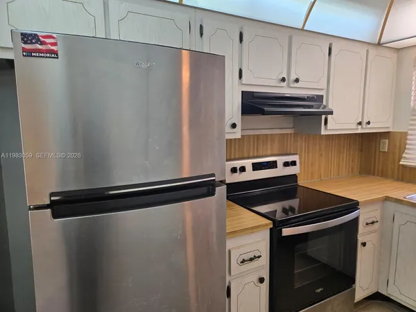 a kitchen with cabinets appliances and a sink