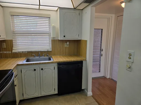 an empty room with wooden floor and a window