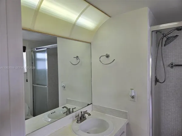 a bathroom with a glass shower door