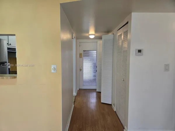 a view of hallway with wooden floor