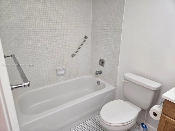 a bathroom with a sink toilet and mirror