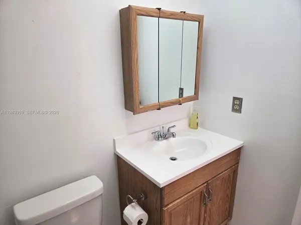 a white toilet sitting next to a bathroom sink