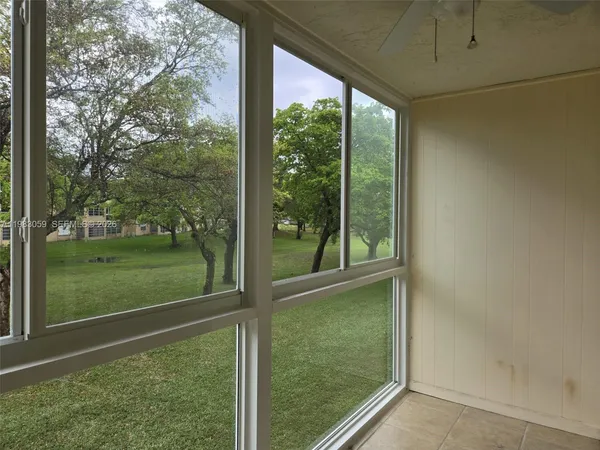 a view of a glass door with a yard
