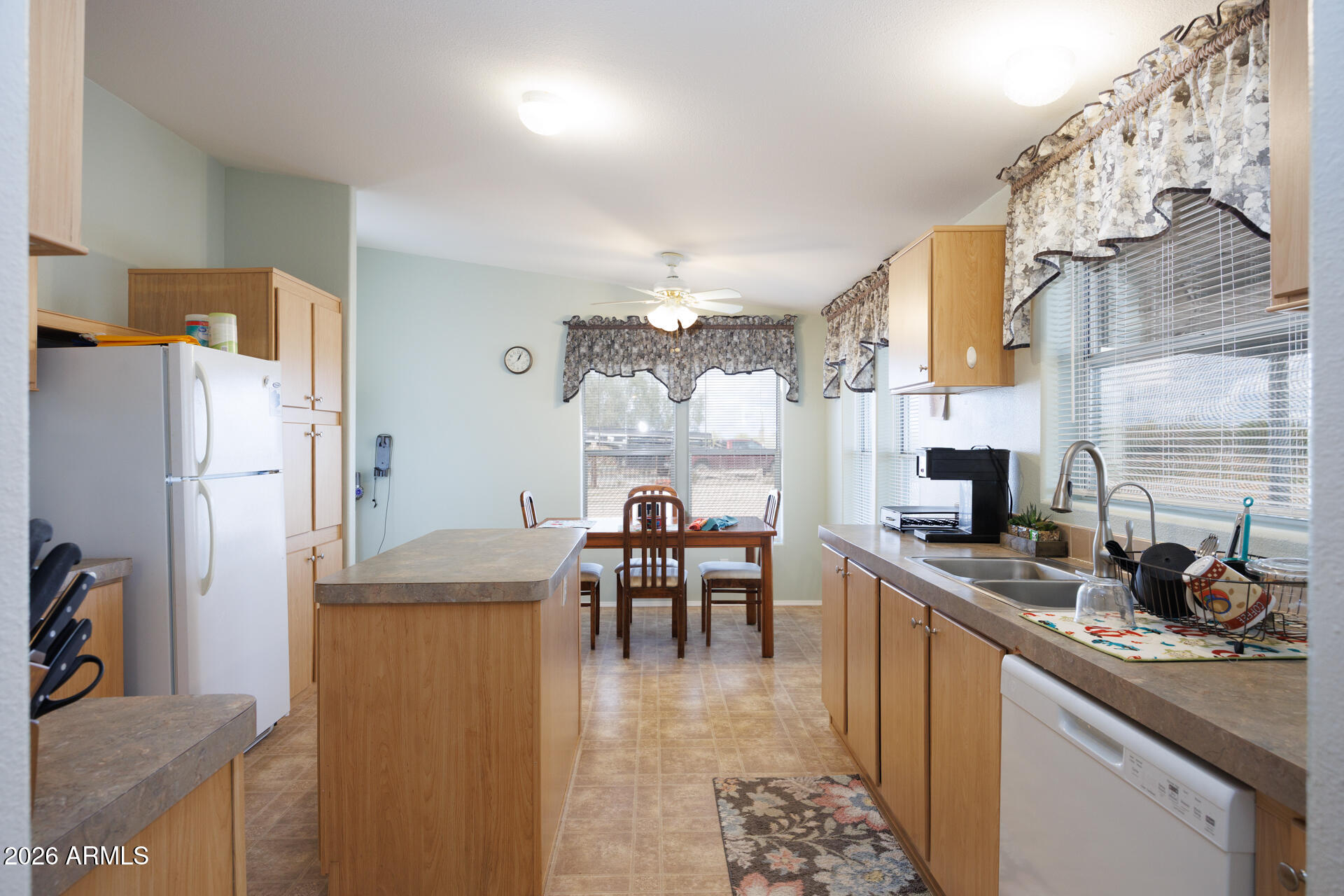 7312 North Reed Road Florence, AZ 85132 - Photo 13 of 66 a kitchen with granite countertop a sink appliances and cabinets