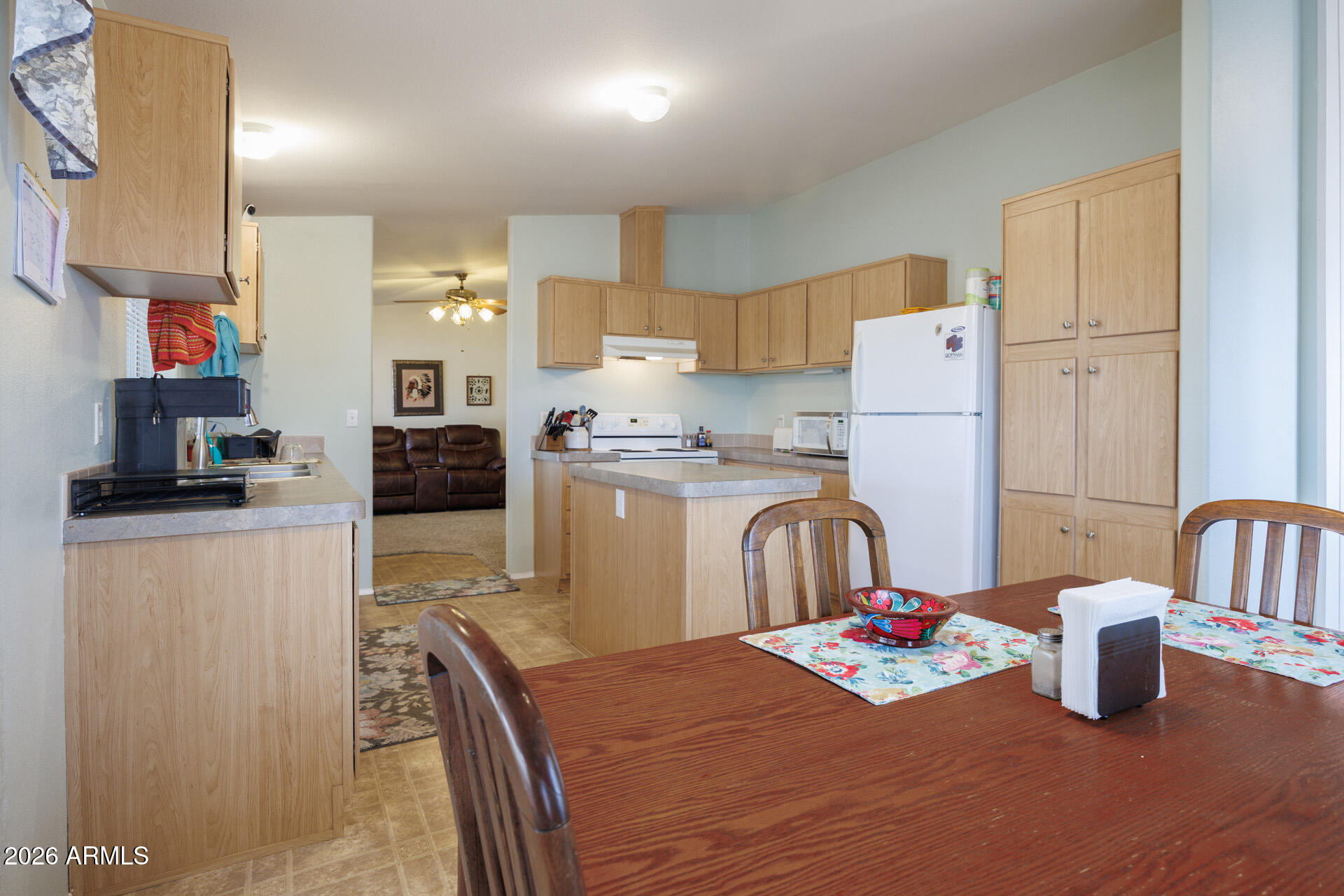 7312 North Reed Road Florence, AZ 85132 - Photo 15 of 66 a kitchen with stainless steel appliances granite countertop a refrigerator a stove a sink a dining table and chairs with wooden floor