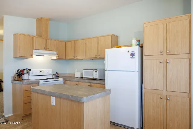 a dining room with furniture a chandelier and window