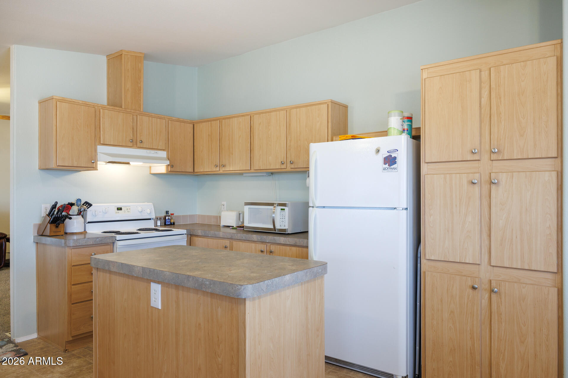 7312 North Reed Road Florence, AZ 85132 - Photo 10 of 66 a white refrigerator freezer sitting in a kitchen