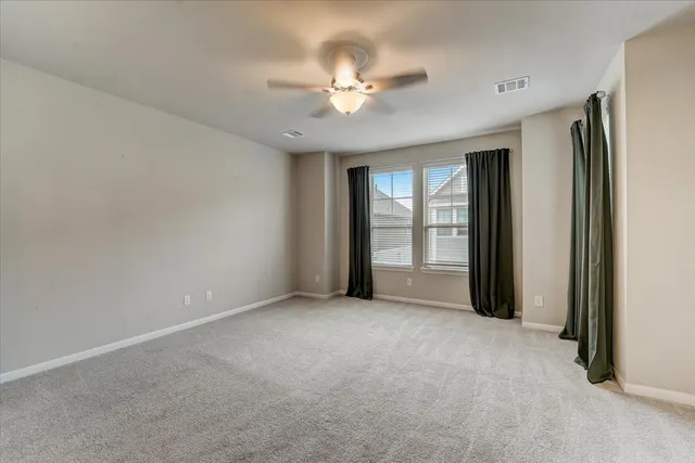 a view of a livingroom with a ceiling fan and window