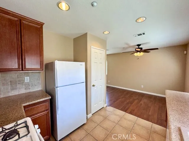 a kitchen with a refrigerator and cabinets