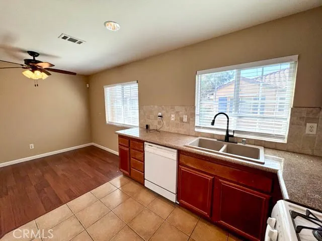 a kitchen with a sink appliances and cabinets