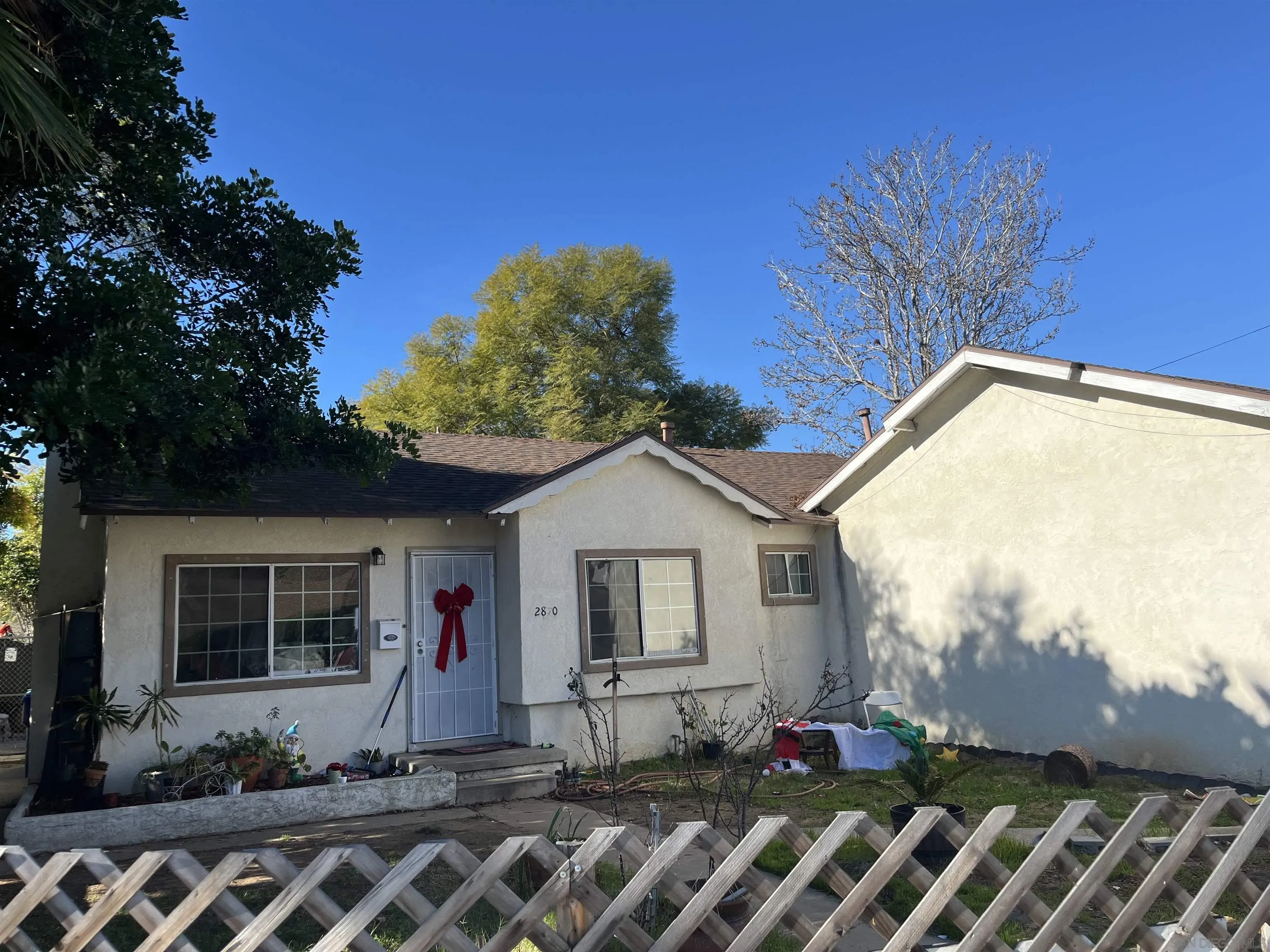 2870 Manos Drive San Diego, CA 92139 - Photo 5 of 7 a front view of a house with garden