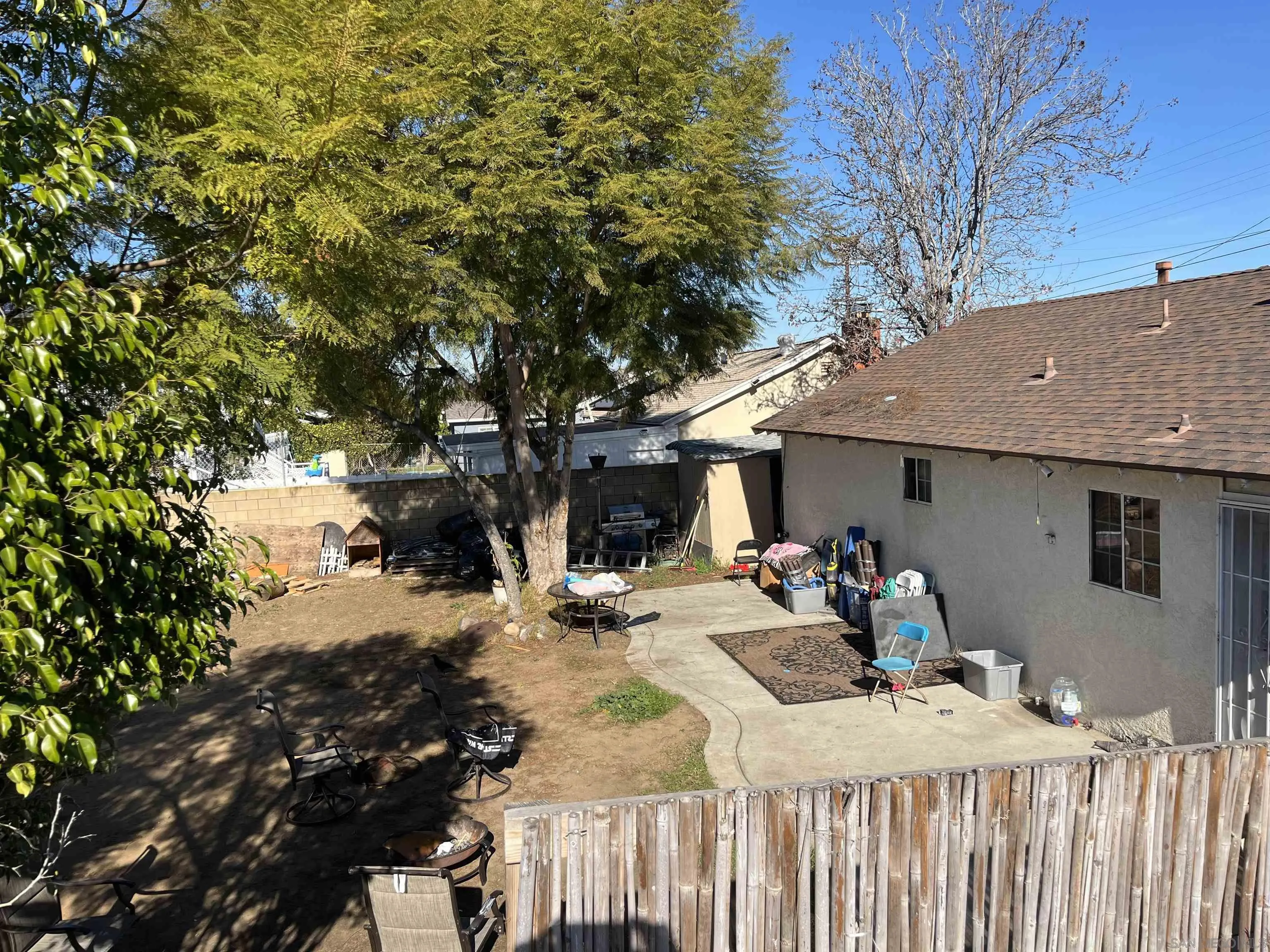 2870 Manos Drive San Diego, CA 92139 - Photo 6 of 7 a view of a backyard that has a tree on the side of it