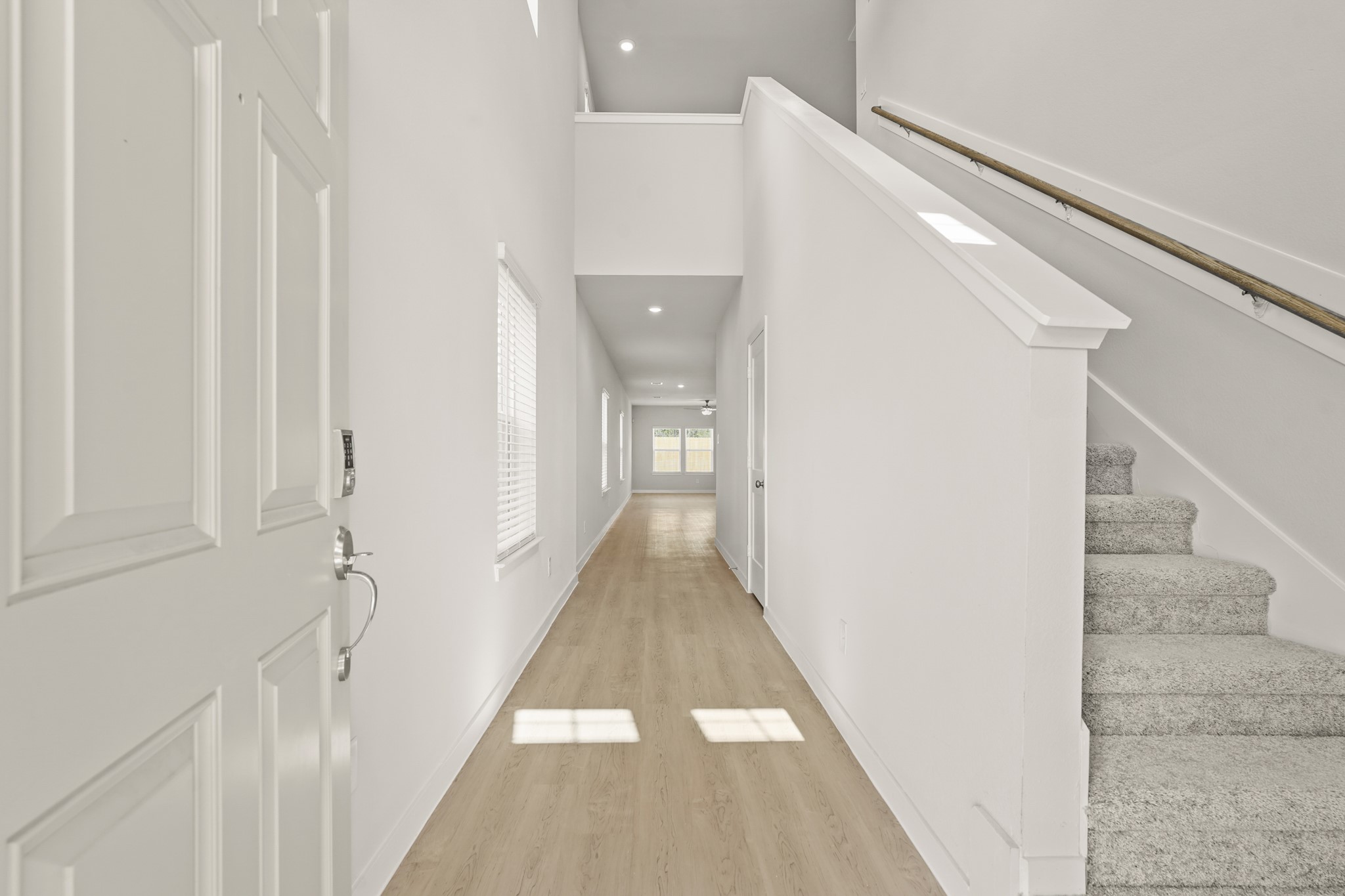 113 Rising Cedar Lane Hockley, TX 77447 - Photo 3 of 27 a view of a hallway with a white walls and stairs