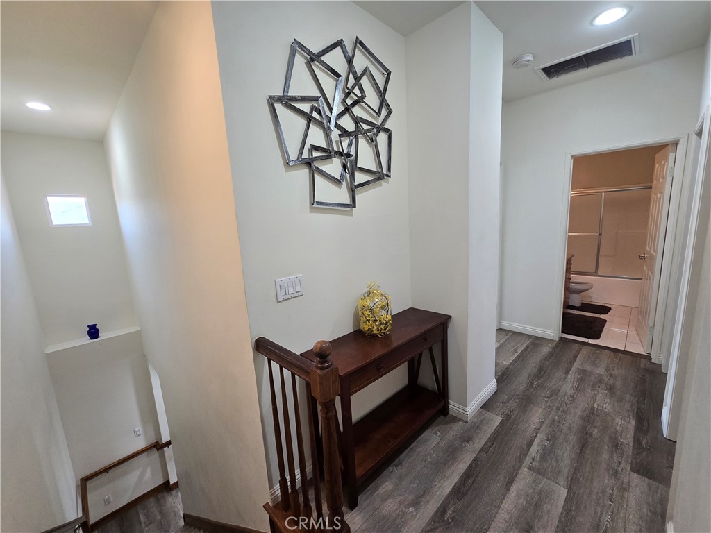 8026 Telegraph Road Downey, CA 90240 - Photo 11 of 26 a view of a hallway with wooden floor and workspace
