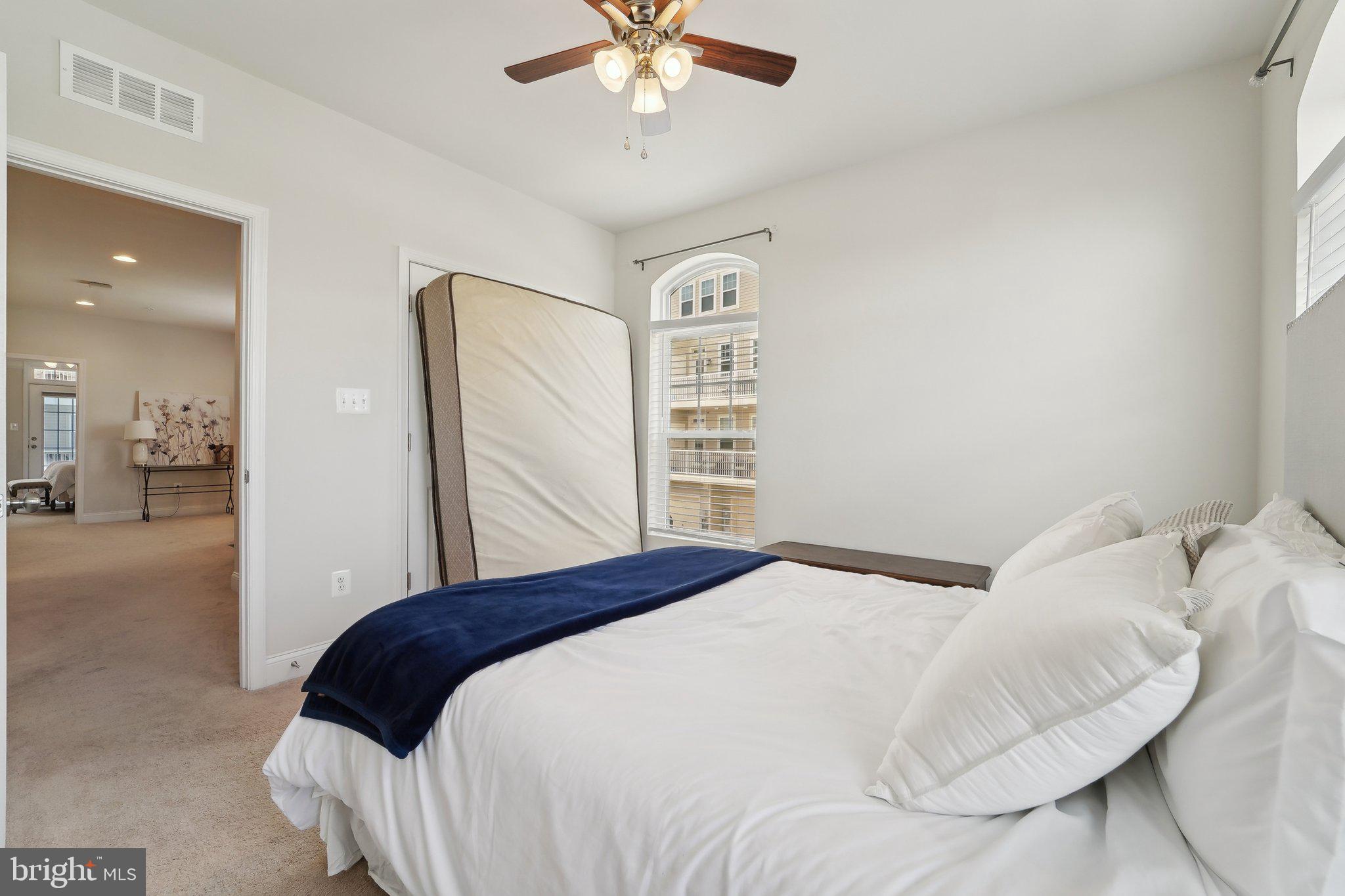 7101 Macon Street Frederick, MD 21703 - Photo 18 of 38 a bedroom with a bed and a ceiling fan