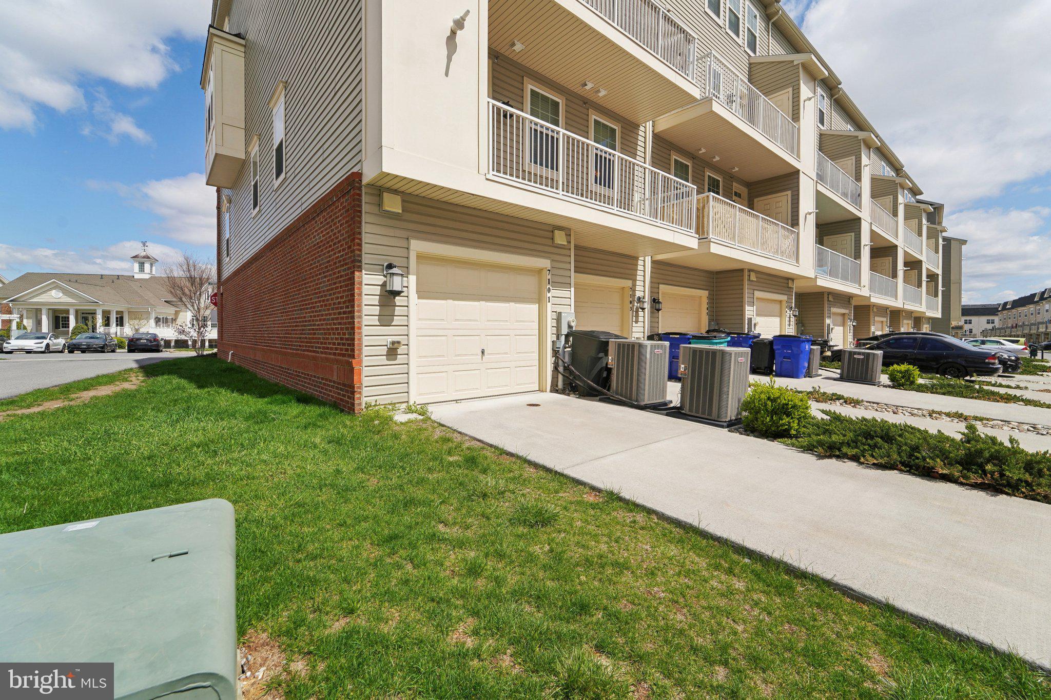 7101 Macon Street Frederick, MD 21703 - Photo 26 of 38 a front view of a building with a yard and plants
