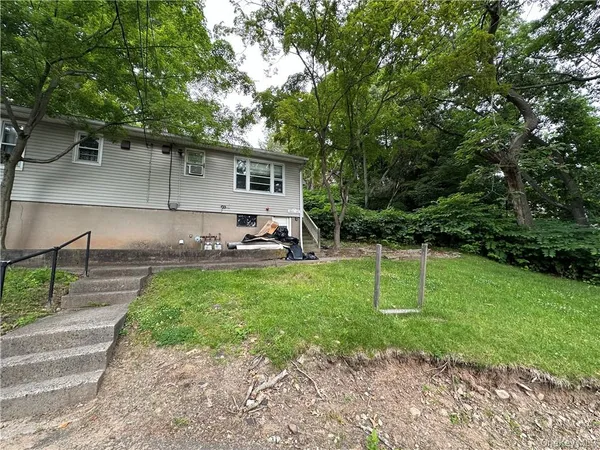 a house view with a sitting space and garden