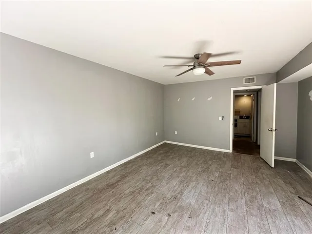an empty room with closet and a window