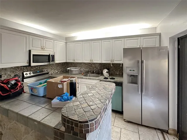 a view of a wooden fence under a large tree