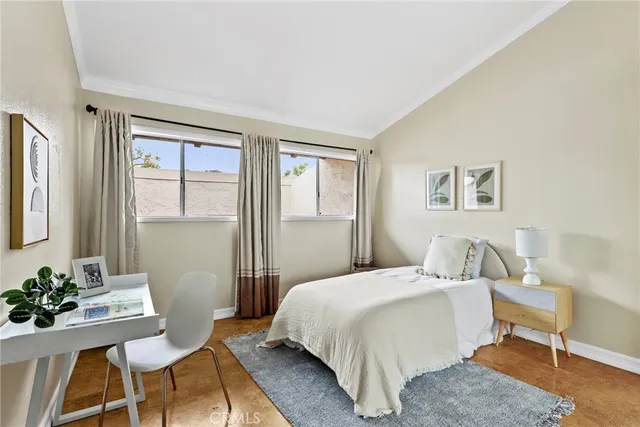 a bedroom with a bed and windows