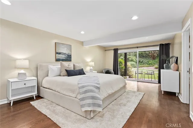 a bedroom with a large bed and a large window