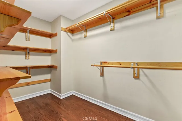 a view of walk in closet with empty racks