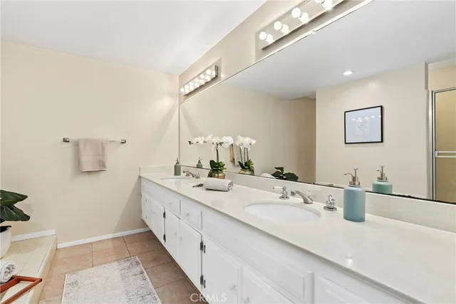 a bathroom with a double vanity sink and a mirror