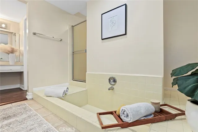 a bathroom with a tub a sink and a shower