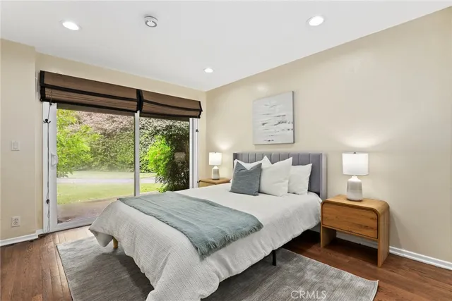 a bedroom with a large bed and a large window