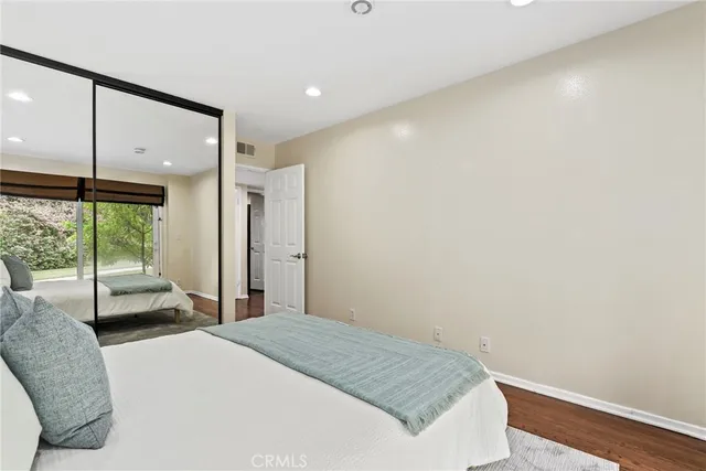 a bedroom with a bed and a large window