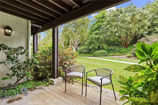 a view of a chairs and table in patio