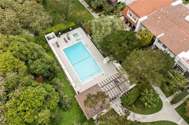 an aerial view of a house with a yard and large trees