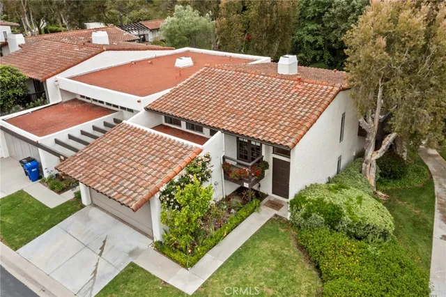 an aerial view of a house with garden space and sitting area