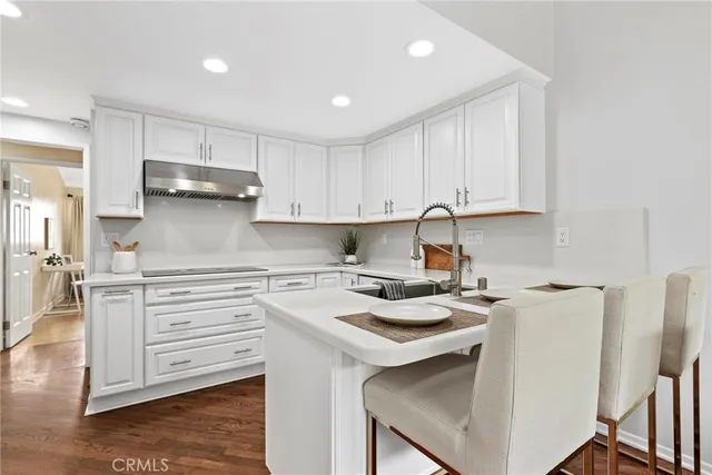 a kitchen with a stove a sink and a refrigerator
