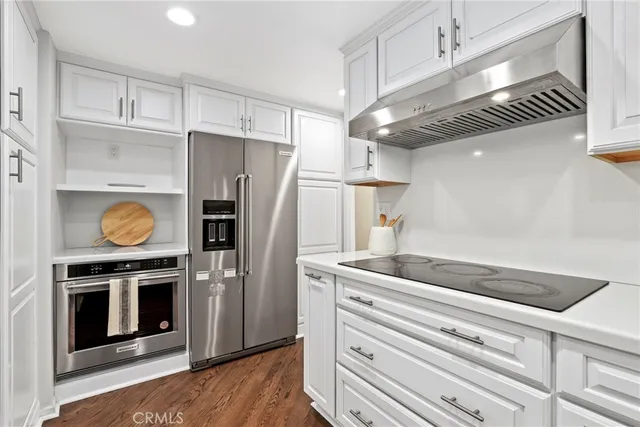 a kitchen with a refrigerator and cabinets