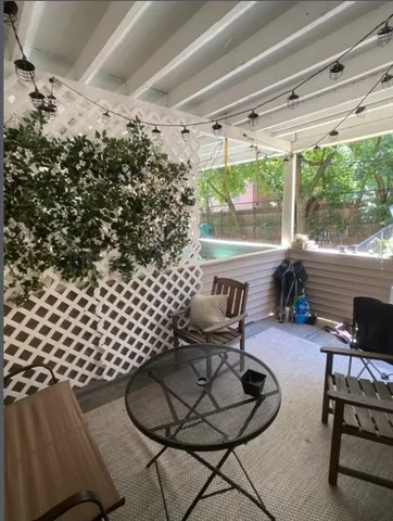 a living room with furniture and a floor to ceiling window
