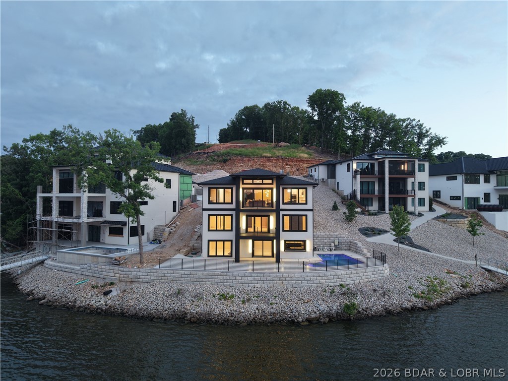 439 Red Bud Road Lake Ozark, MO 65049 - Photo 82 of 98 Sunset exterior capturing the home's dramatic arch