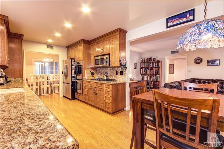 2273 Keystone Street Simi Valley, CA 93063 - Photo 11 of 29 a kitchen with stainless steel appliances kitchen island granite countertop a stove a sink and a refrigerator