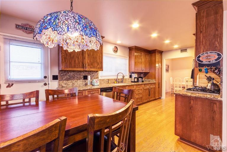 2273 Keystone Street Simi Valley, CA 93063 - Photo 12 of 29 a kitchen with stainless steel appliances granite countertop a stove top oven a sink dishwasher and cabinets with wooden floor