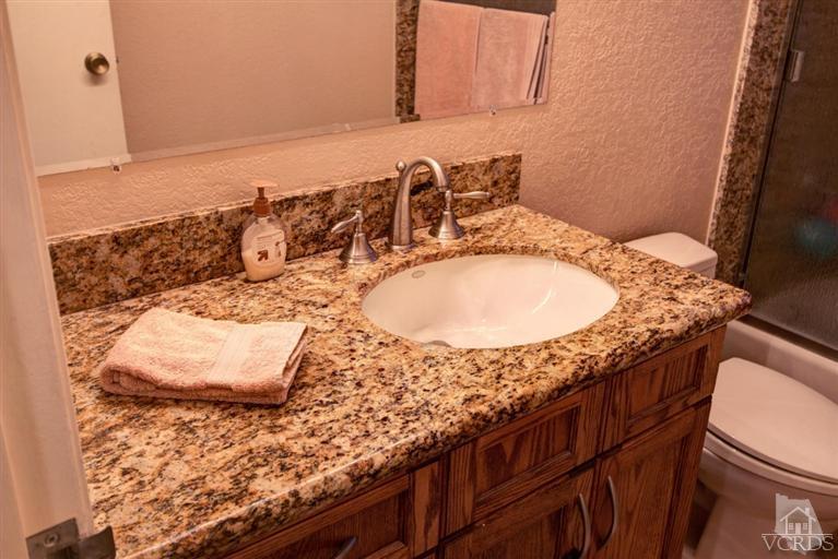 2273 Keystone Street Simi Valley, CA 93063 - Photo 20 of 29 a bathroom with a granite countertop sink and mirror