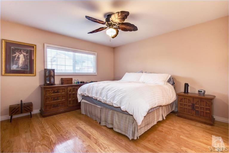 2273 Keystone Street Simi Valley, CA 93063 - Photo 23 of 29 a bedroom with a bed and a chandelier